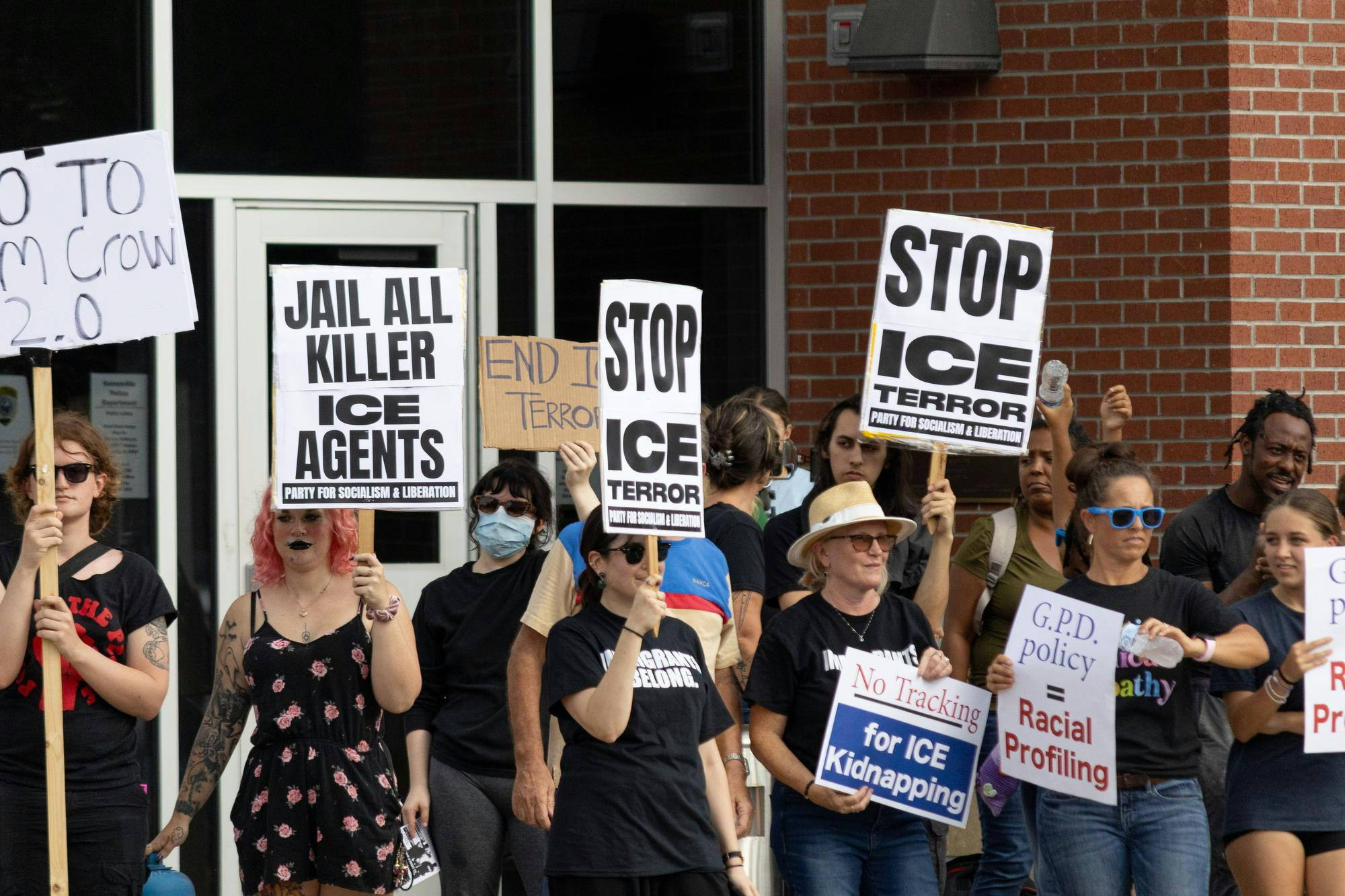 Protestors hold up signs at an anti-ICE protest in front of the GPD headquarters in Gainesville, Fla., Thursday, Sept. 3, 2026.
