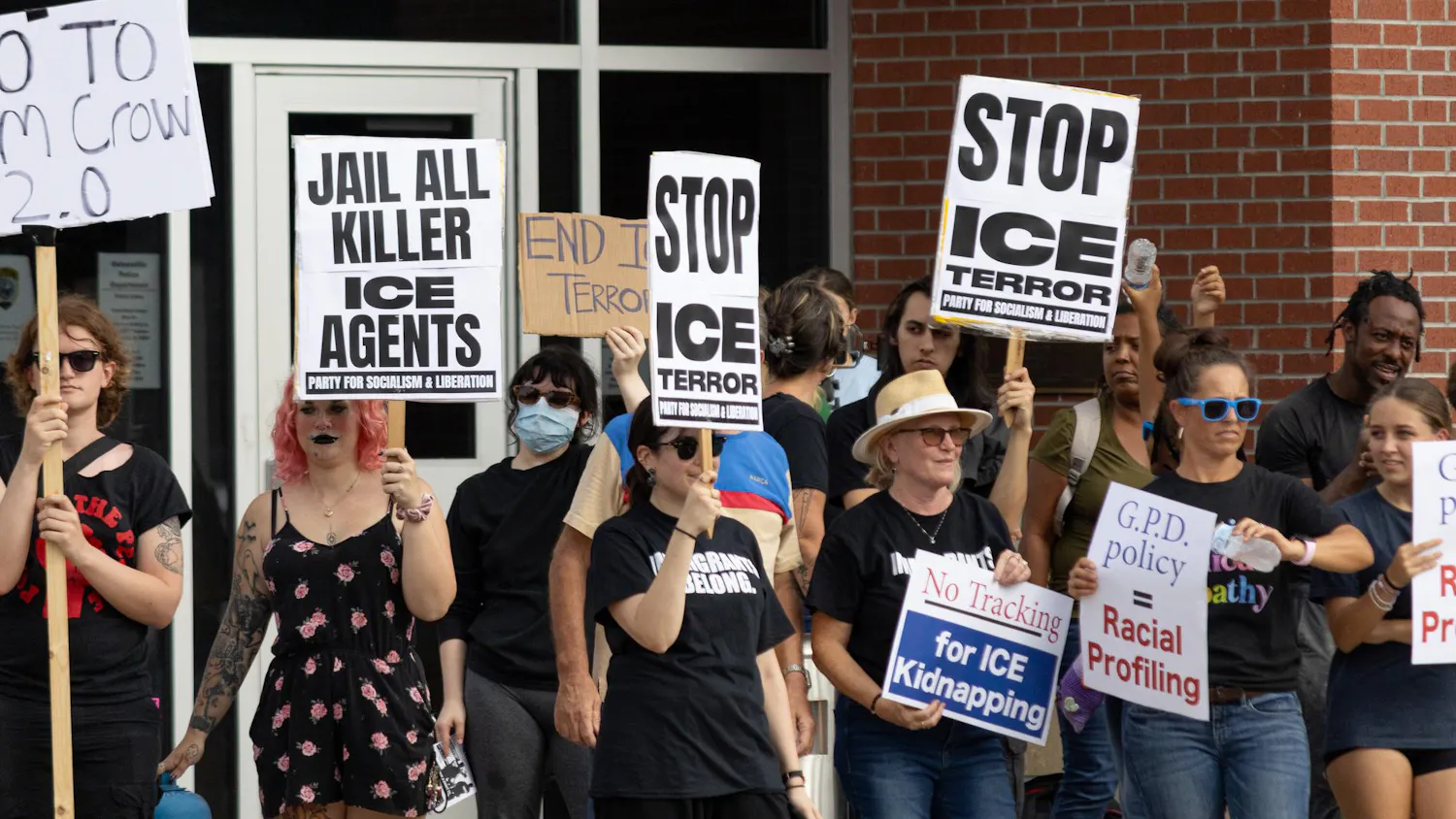 Protestors hold up signs at an anti-ICE protest in front of the GPD headquarters in Gainesville, Fla., Thursday, Sept. 3, 2026.