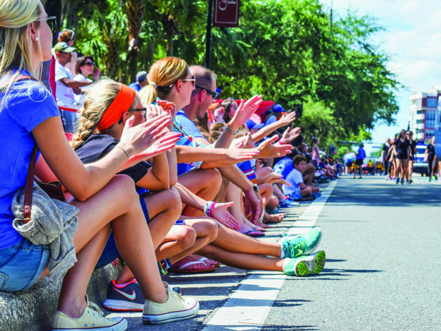 The crowd Gator Chomps in spirit of this year’s UF Homecoming Parade on Friday on West University Avenue.