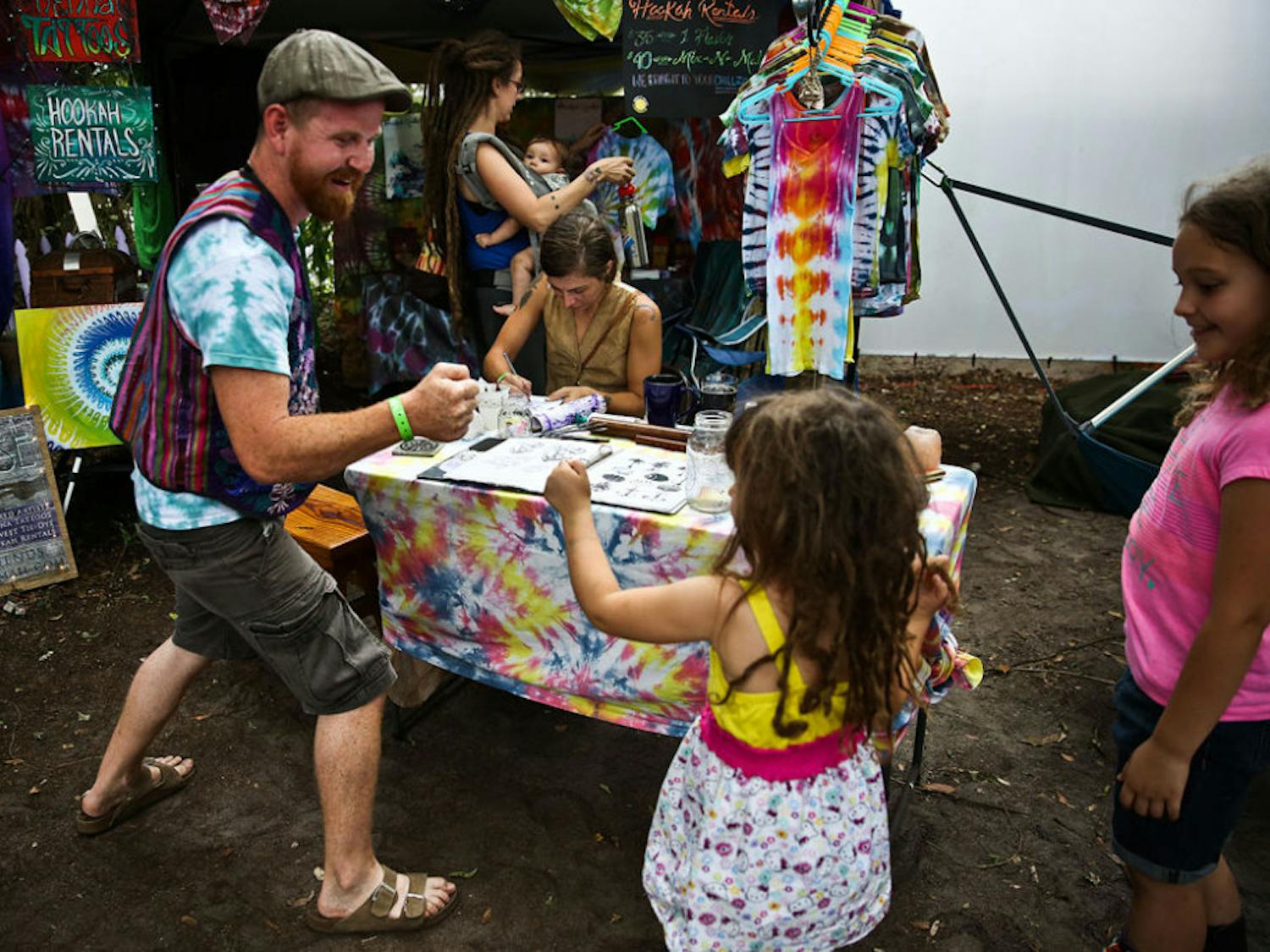 Sean Duncan, a 28-year-old Gypsy Paradise &amp; Friends artist, practices a fist bump with Ileana Rodriguez, 4, during Spirit Fest at The Jam on Sunday. The three-day festival featured more than 30 live music acts, as well as food, hand-made clothing and art to celebrate the venue's closing.