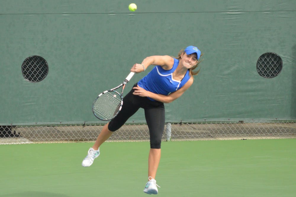 Kourtney Keegan serves the ball during her doubles match in Florida's 4-0 win against Louisville on Saturday.