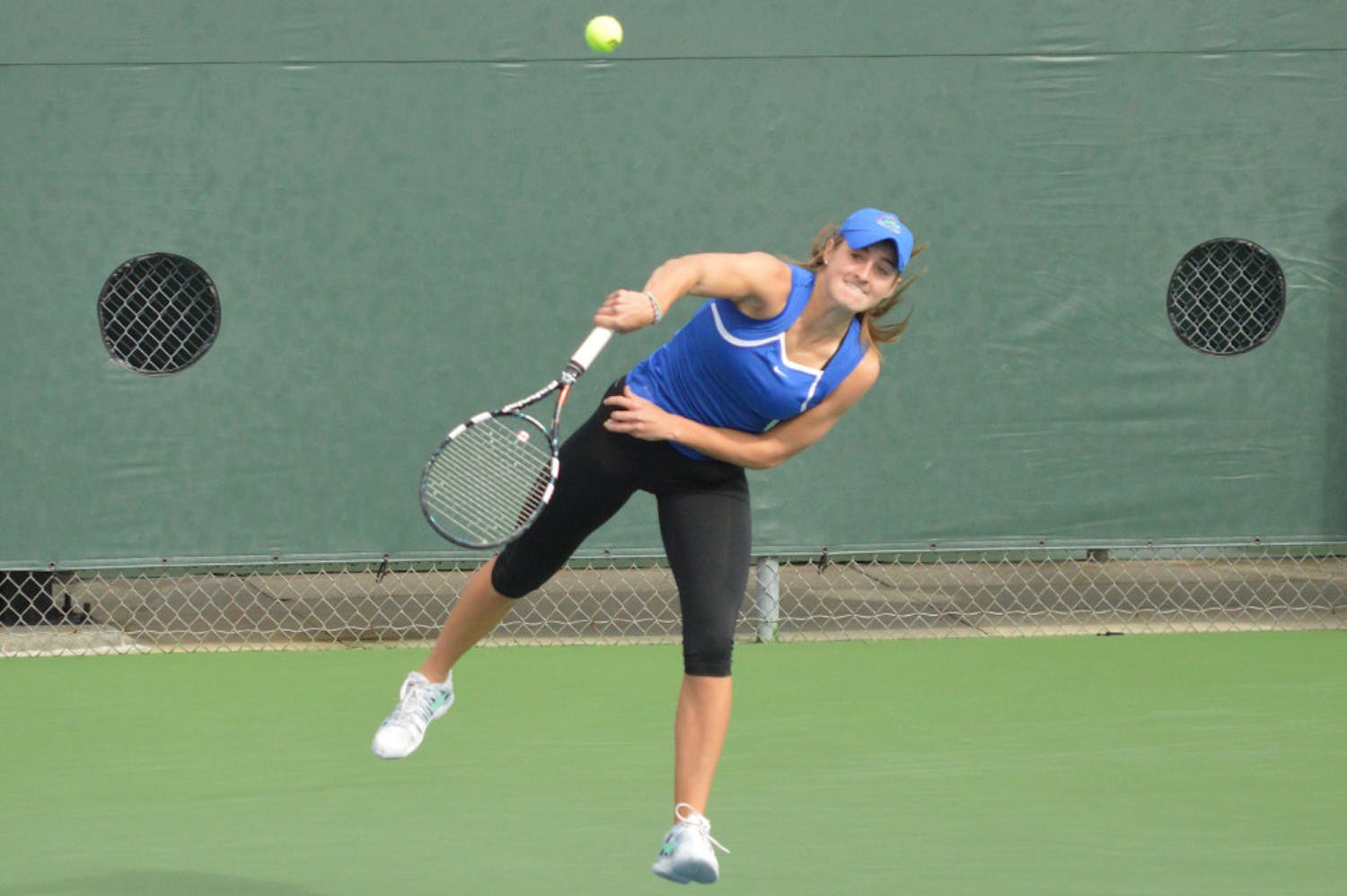 Kourtney Keegan serves the ball during her doubles match in Florida's 4-0 win against Louisville on Saturday.