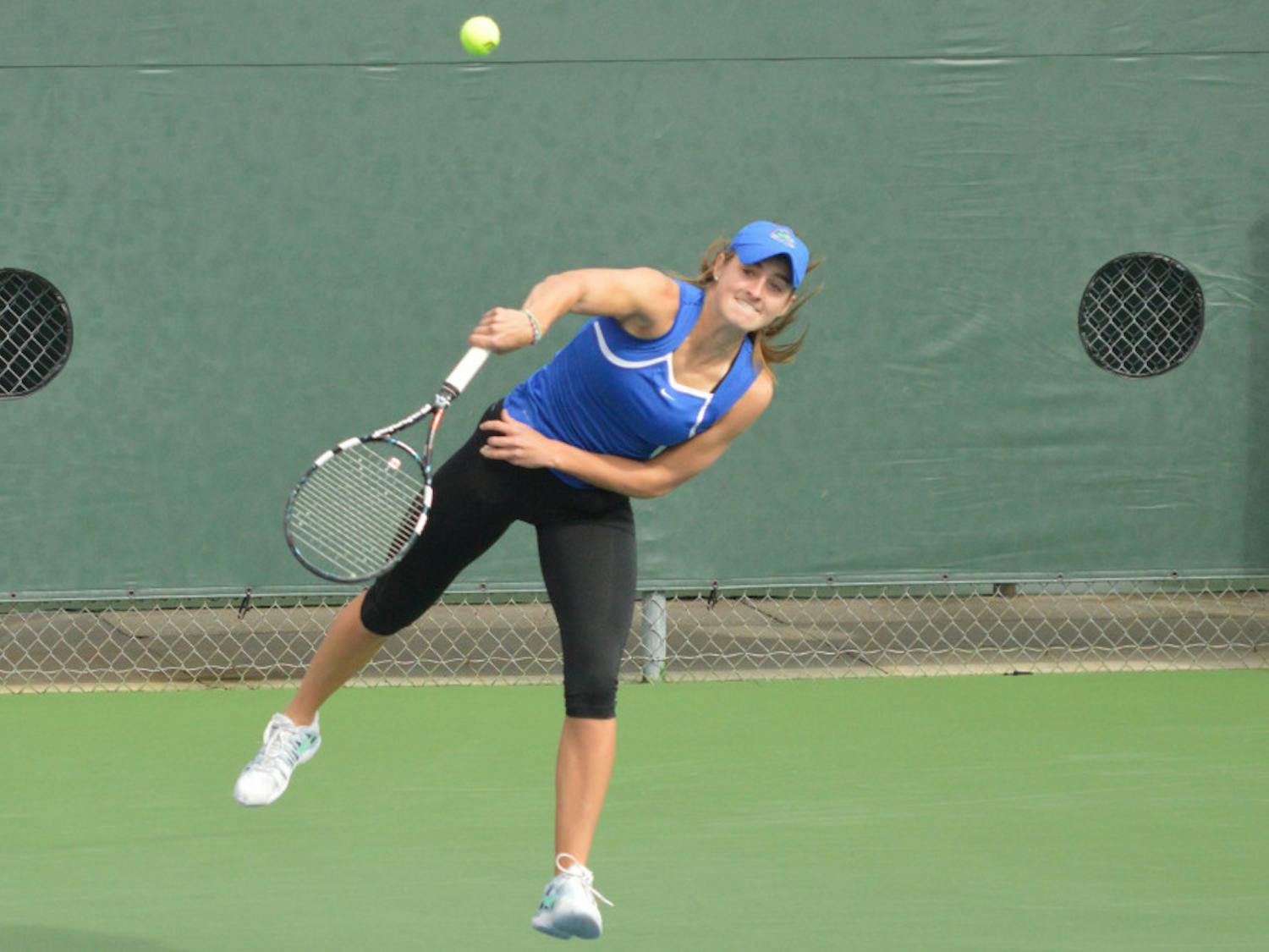 Kourtney Keegan serves the ball during her doubles match in Florida's 4-0 win against Louisville on Saturday.