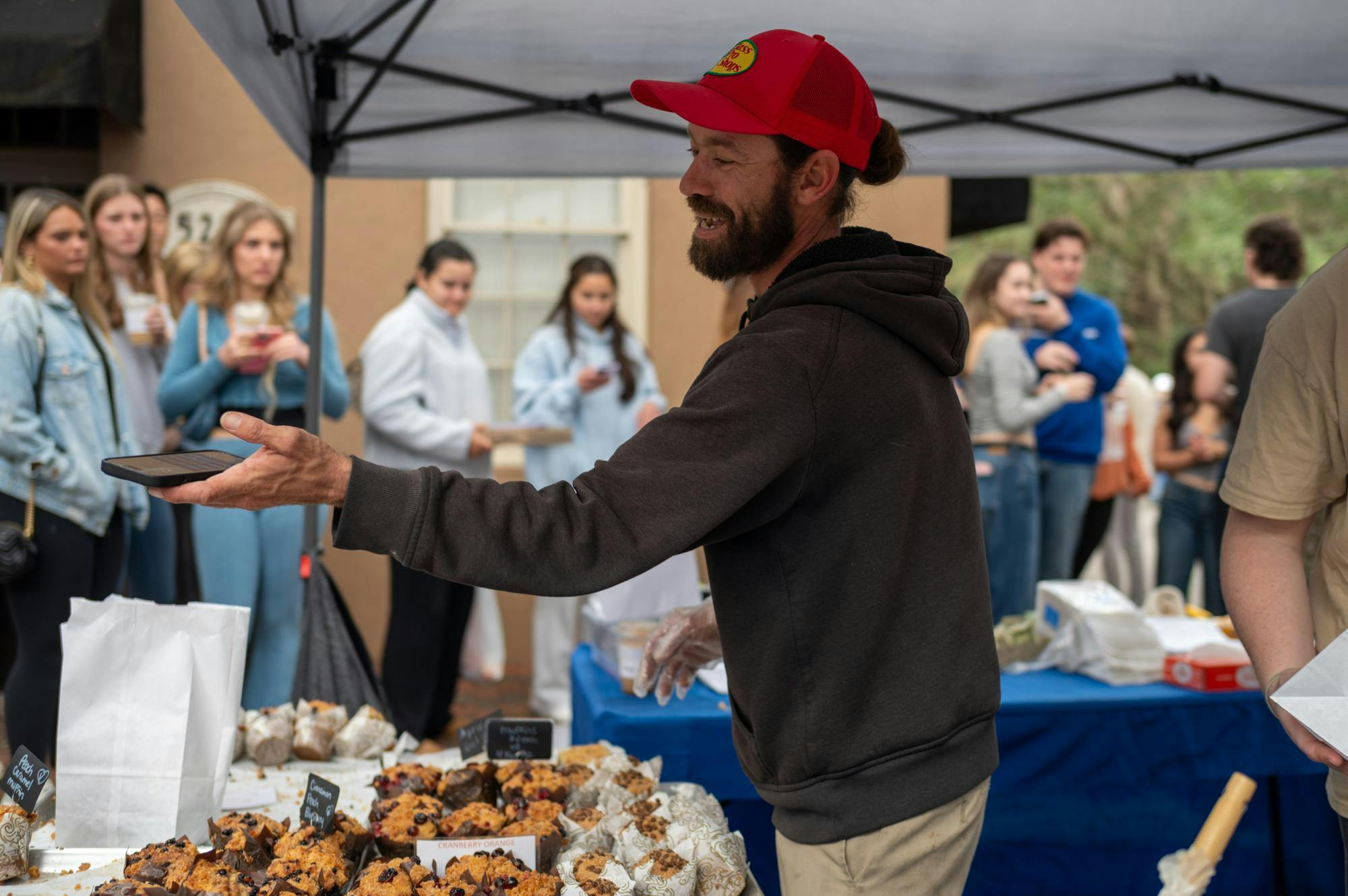 The Gourmet Muffin, a bakery based in Stuart, Fla., is one of the most popular vendors at Haile Plantation Farmers Market. A line wraps around their tent in Gainesville, Saturday, Jan. 24, 2026.