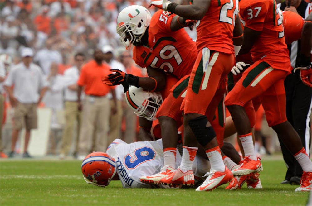 <p>Jeff Driskel lies on the ground after being sacked by a group of Miami defenders during the Gators’ 21-16 loss to the Hurricanes on Saturday in Sun Life Stadium. Driskel had three turnovers in the game.</p>