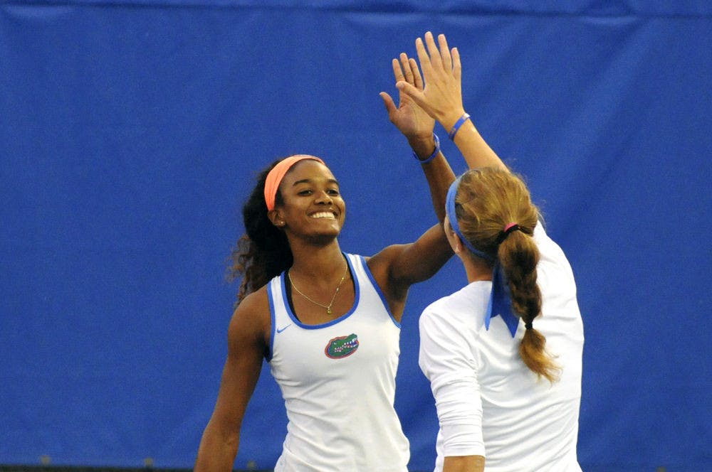 <p>UF doubles tandem Brianna Morgan and Anna Danilina celebrate during Florida’s win over USF on Jan. 27, 2016, at the Ring Tennis Complex.</p>