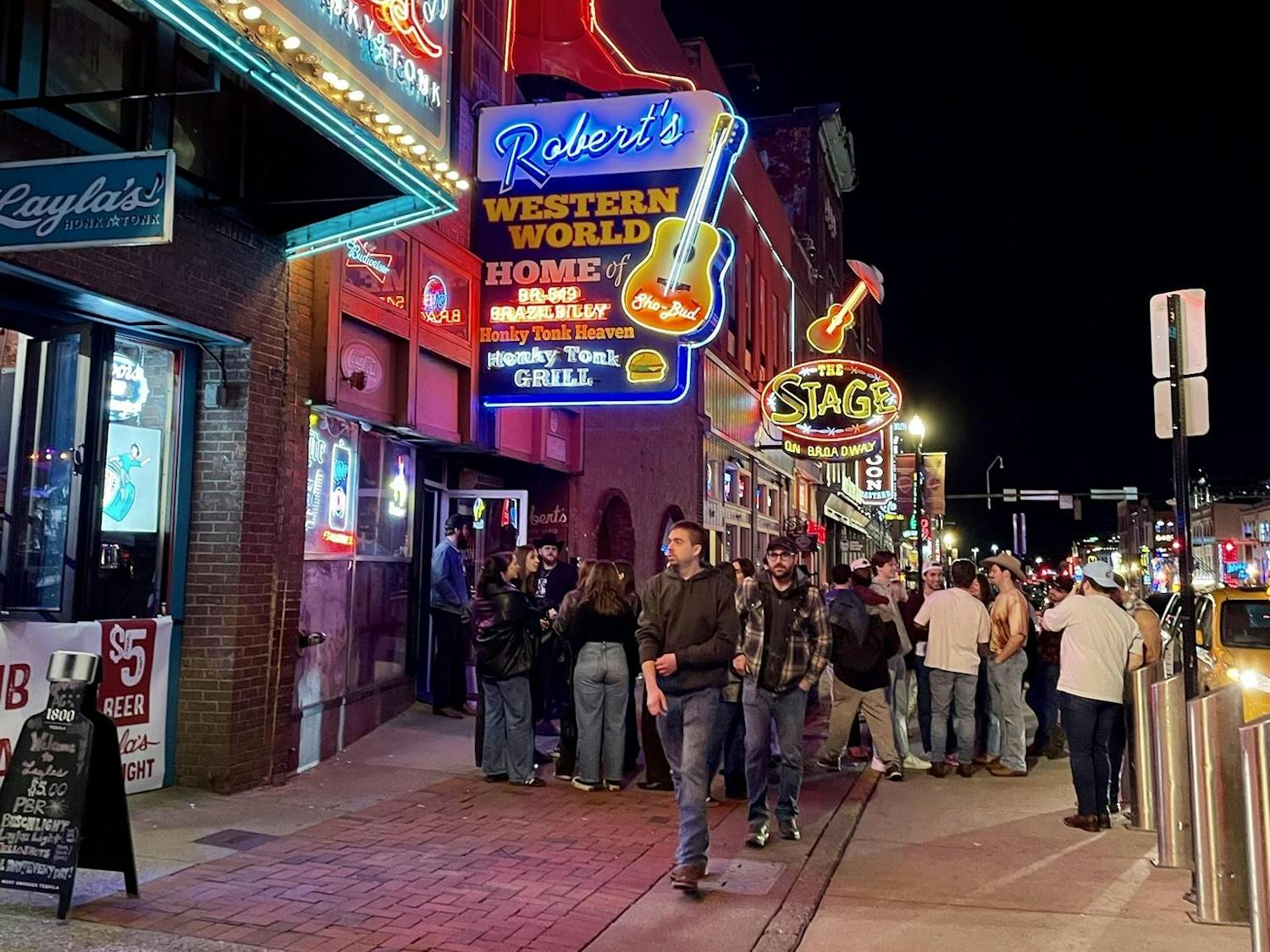 People gather outside Robert’s Western World, Friday, Feb. 20, 2026, on Broadway in downtown Nashville, Tenn.
