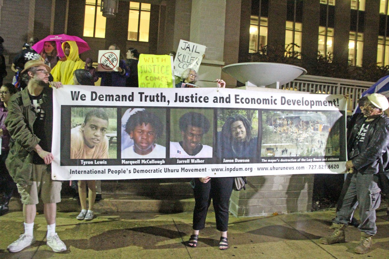 In response to the Ferguson trial verdict, a group of protesters gather at the Gainesville Courthouse downtown to voice their opinions. The rain did not detour the group of individuals from chanting and singing.&nbsp;