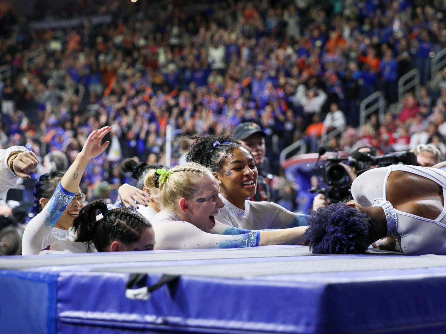 Gators gymnasts congratulate Florida graduate student Trinity Thomas after her uneven bars routine that gave her one of her two perfect 10s in the Southeastern Conference Championships Saturday, March 18, 2023.