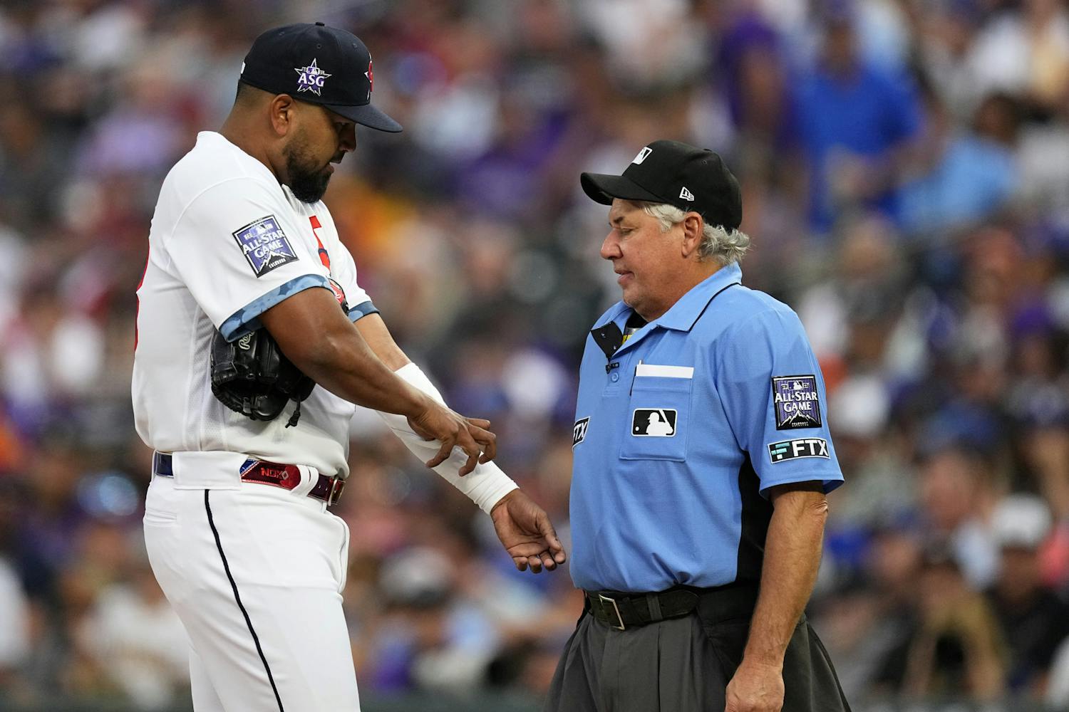 Home plate umpire Tom Hallion, right, checks for foreign substances on National League's German Marquez, of the Colorado Rockies, during the fourth inning of the MLB All-Star baseball game, Tuesday, July 13, 2021, in Denver. (AP Photo/Jack Dempsey)