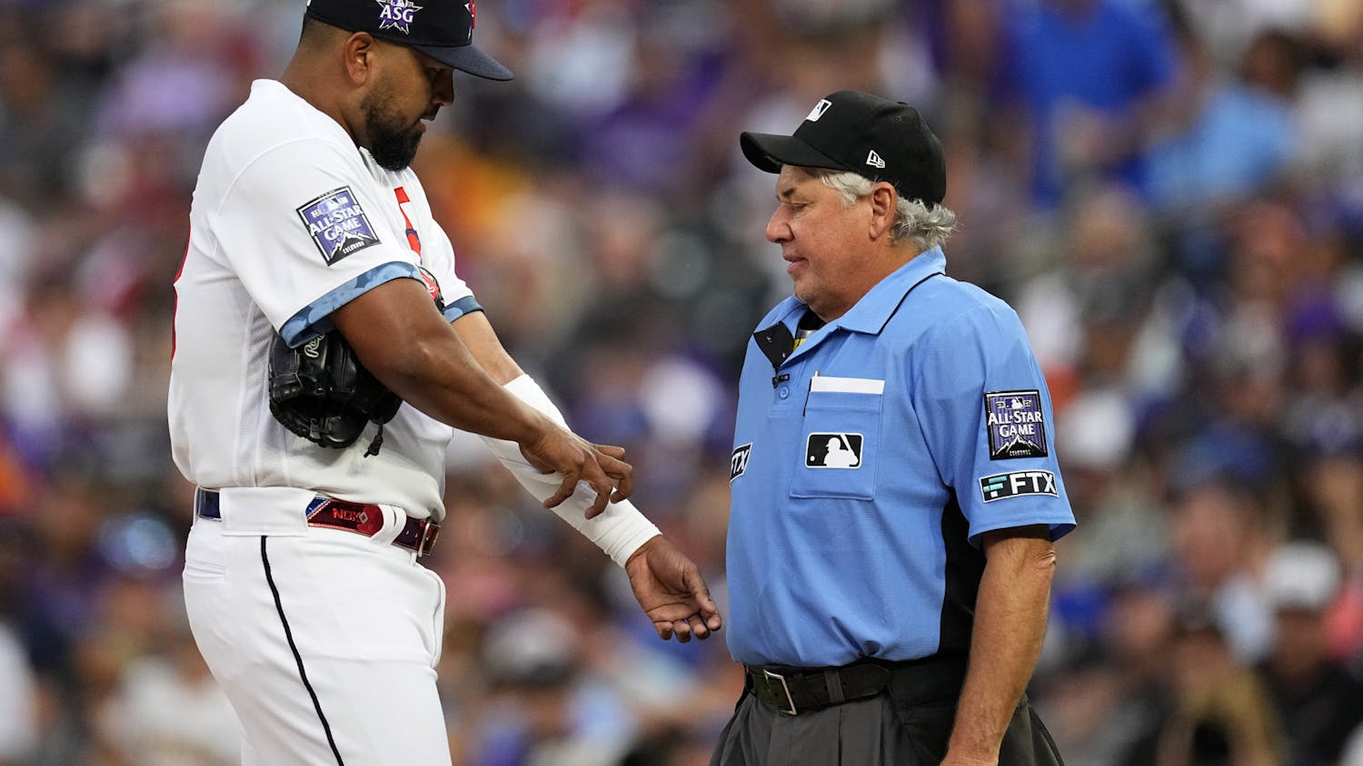 Home plate umpire Tom Hallion, right, checks for foreign substances on National League's German Marquez, of the Colorado Rockies, during the fourth inning of the MLB All-Star baseball game, Tuesday, July 13, 2021, in Denver. (AP Photo/Jack Dempsey)