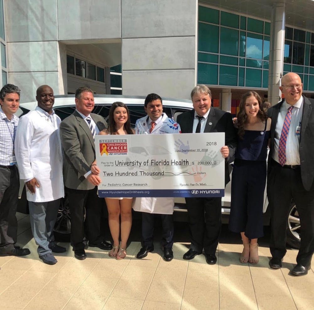 UF Shands Hospital staff and pediatric cancer survivors join Dr. Paul Castillo at the Hyundai Hope on Wheels Handprint Ceremony where he received a $200,000 grant on Sept. 18.