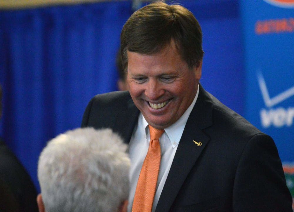<p>New head football coach Jim McElwain following his introductory press conference on Saturday at Ben Hill Griffin Stadium.</p>