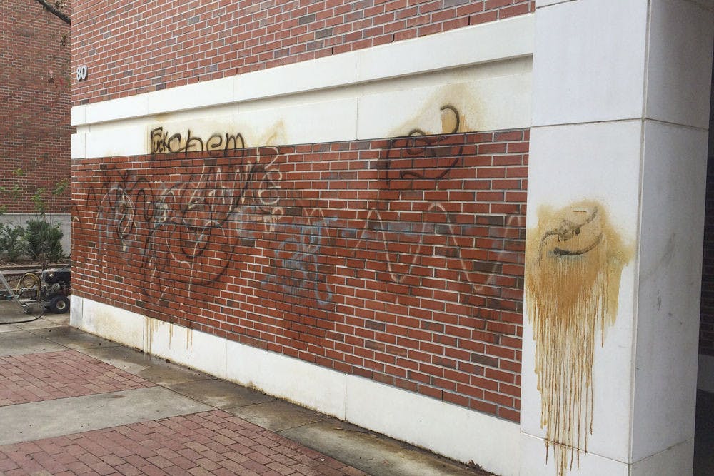 <p>Pictured is a slew of graffiti painted outside Flint Hall. Acts of vandalism aren’t uncommon, said a UF physical plant worker; when spray paint is involved, chemicals and pressure washing is required to remove the graffiti.</p>