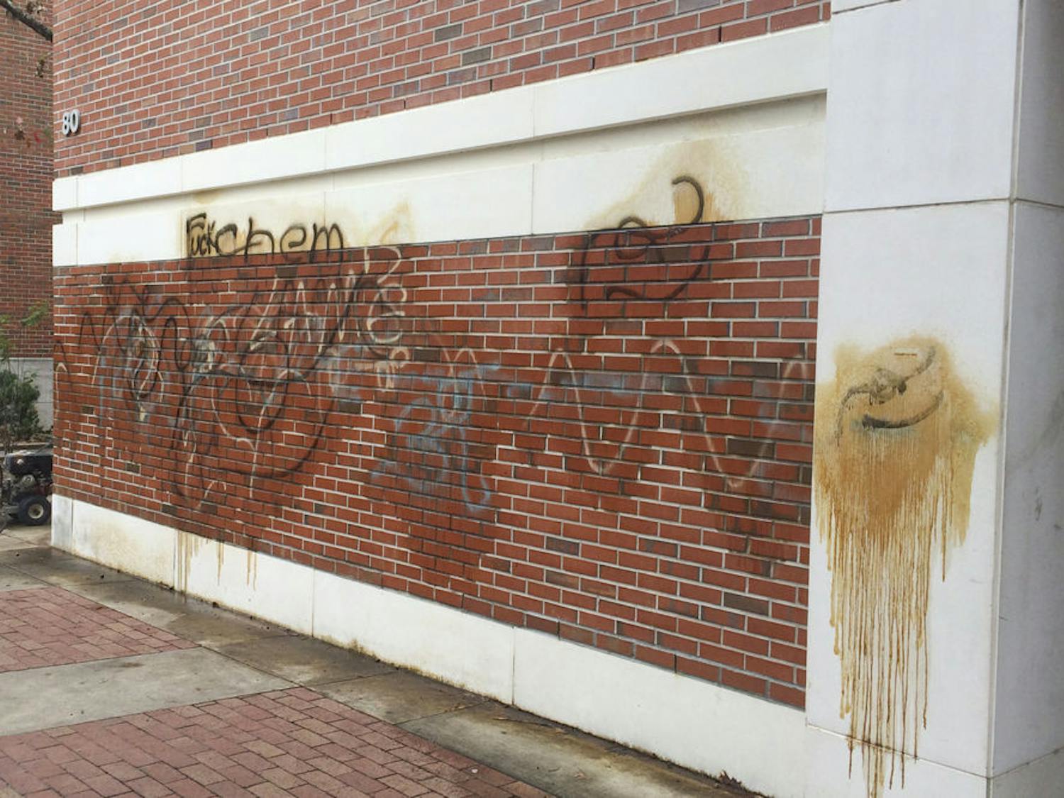 Pictured is a slew of graffiti painted outside Flint Hall. Acts of vandalism aren’t uncommon, said a UF physical plant worker; when spray paint is involved, chemicals and pressure washing is required to remove the graffiti.