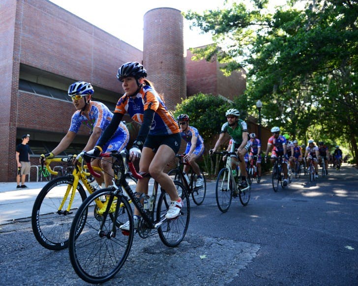 Karen Edmonds leads a pack of cyclists past the Fine Arts building Monday afternoon. The Florida Cycling club organized the 12-mile ride to honor Edmonds’ late brother, Michael Edmonds.