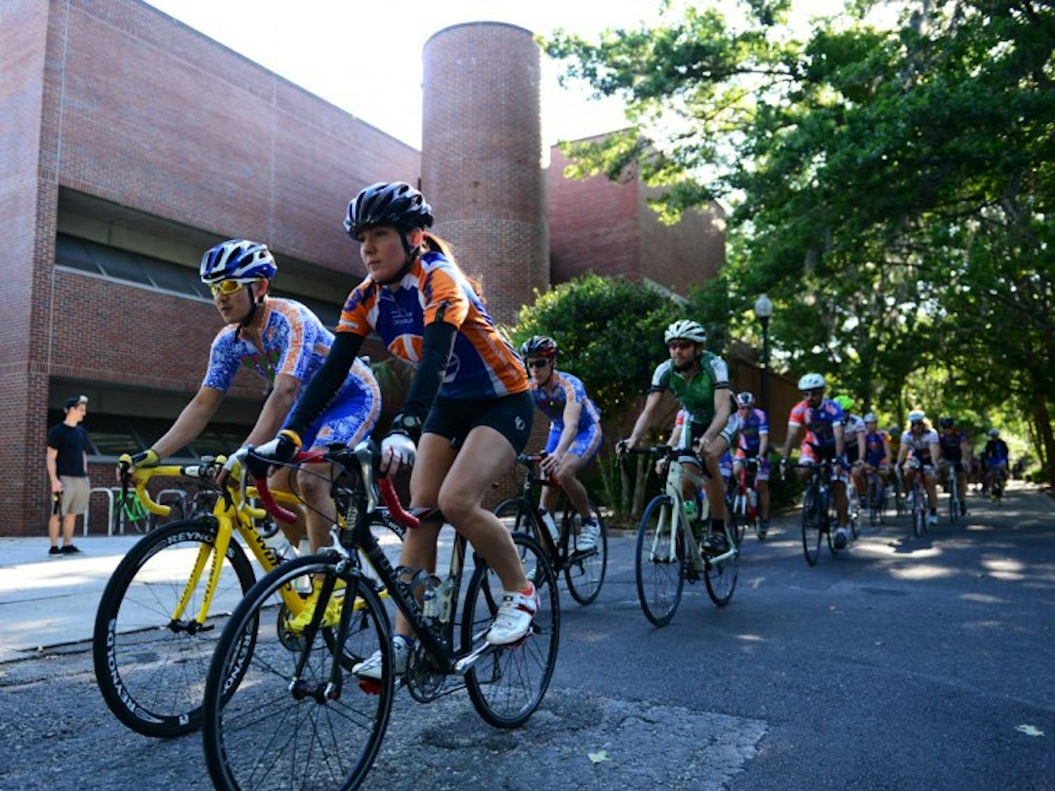 Karen Edmonds leads a pack of cyclists past the Fine Arts building Monday afternoon. The Florida Cycling club organized the 12-mile ride to honor Edmonds’ late brother, Michael Edmonds.