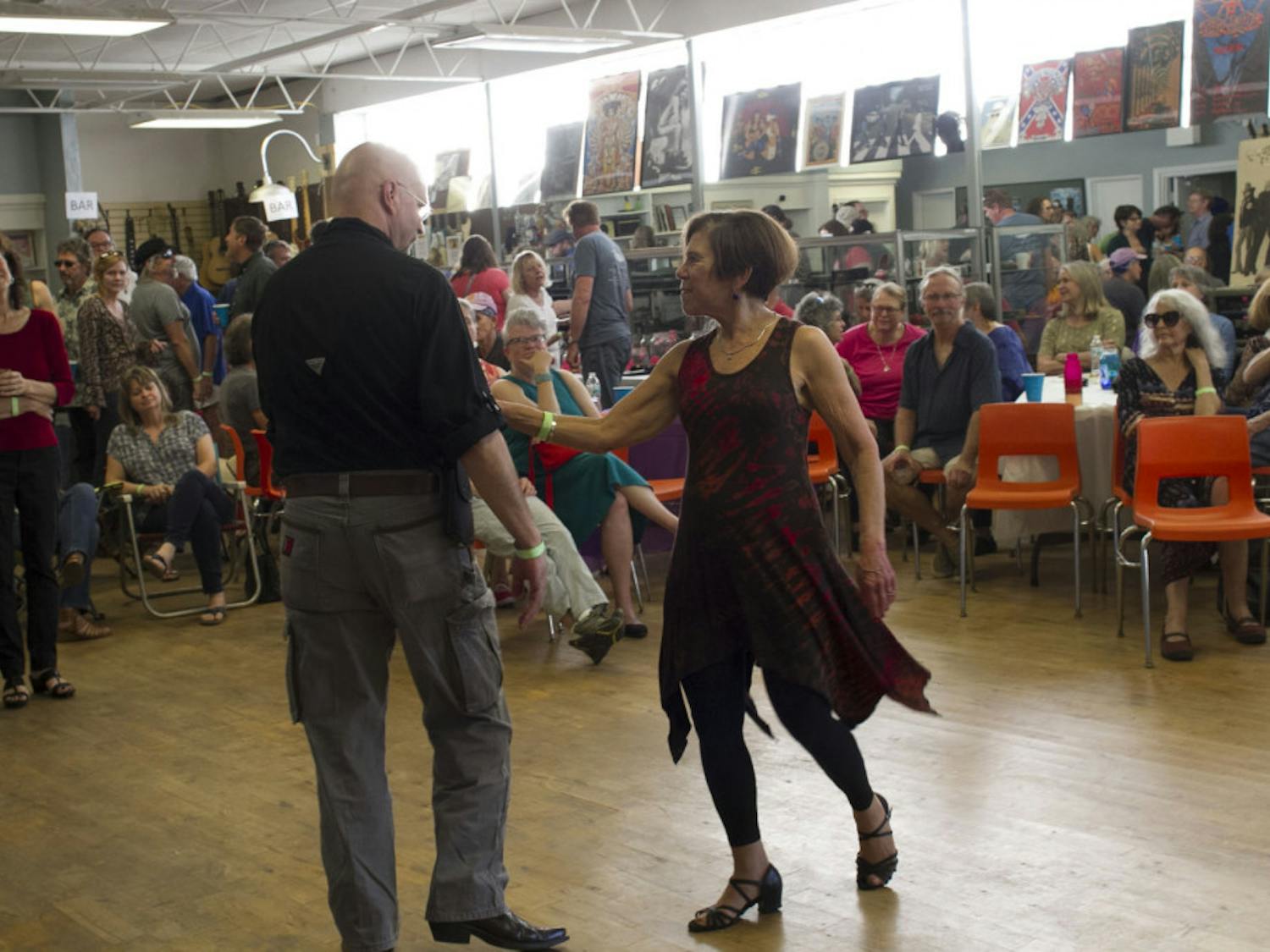 Carol Perrine (far left) watches as two of her friends dance at the Carolpalooza&nbsp;benefit concert.
&nbsp;