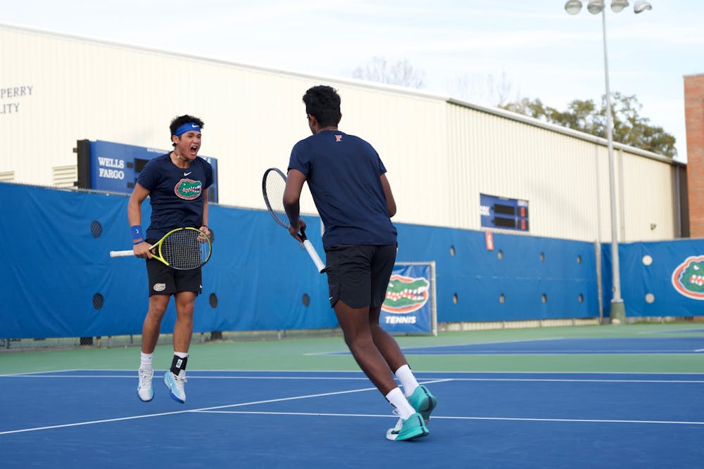 Sophomore Tanapatt Nirundorn (left) and freshman Adhithya Ganesan (right) celebrate after a point in the Gators men's tennis team's match against North Florida on Friday, January 19, 2024. 