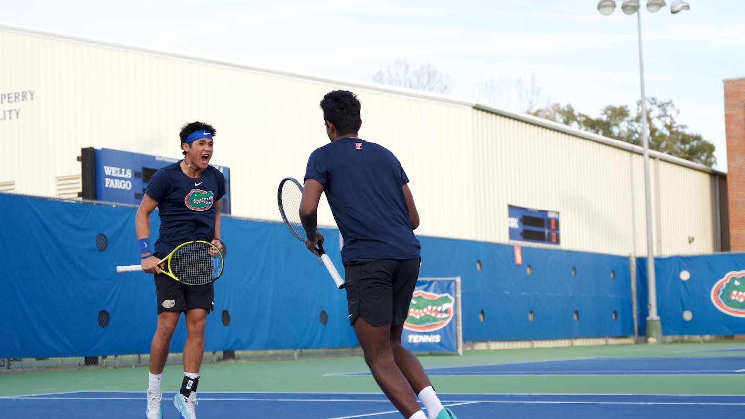 Sophomore Tanapatt Nirundorn (left) and freshman Adhithya Ganesan (right) celebrate after a point in the Gators men's tennis team's match against North Florida on Friday, January 19, 2024. 