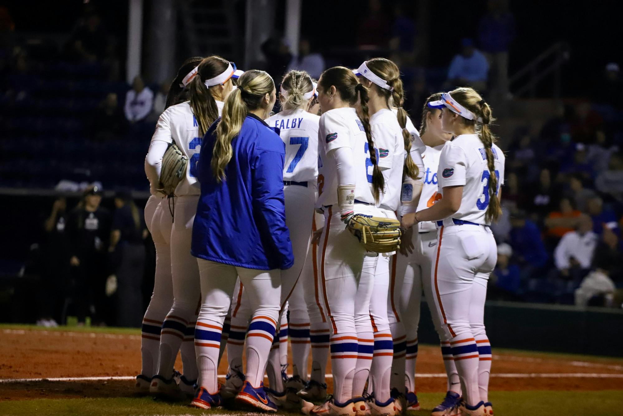 Florida softball huddles on the field to talk strategy against Mississippi State on March 14, 2022. The Gators compiled too many errors Friday night, falling to No. 7 Arkansas by a 9-1 score.