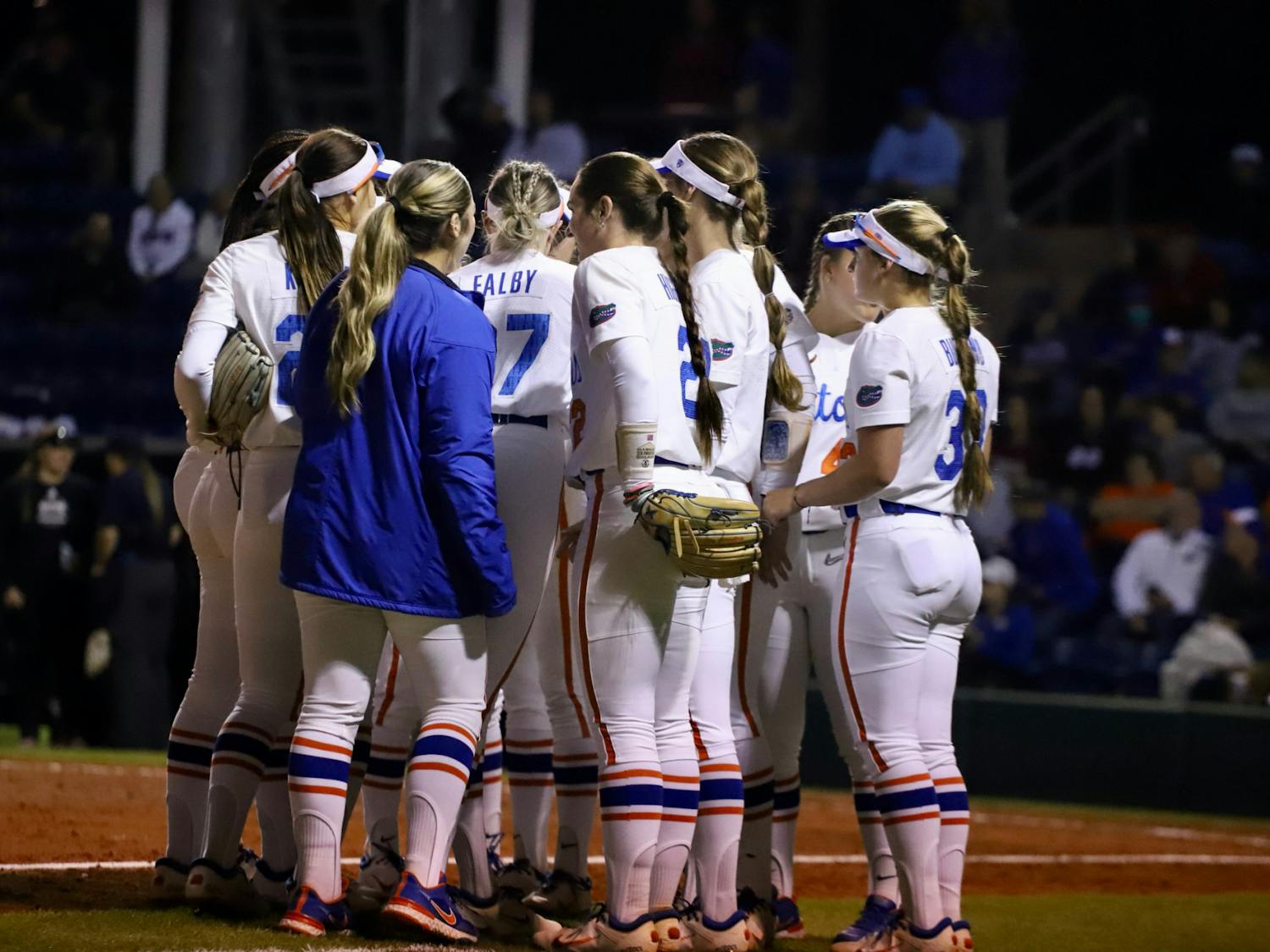 Florida softball huddles on the field to talk strategy against Mississippi State on March 14, 2022. The Gators compiled too many errors Friday night, falling to No. 7 Arkansas by a 9-1 score.