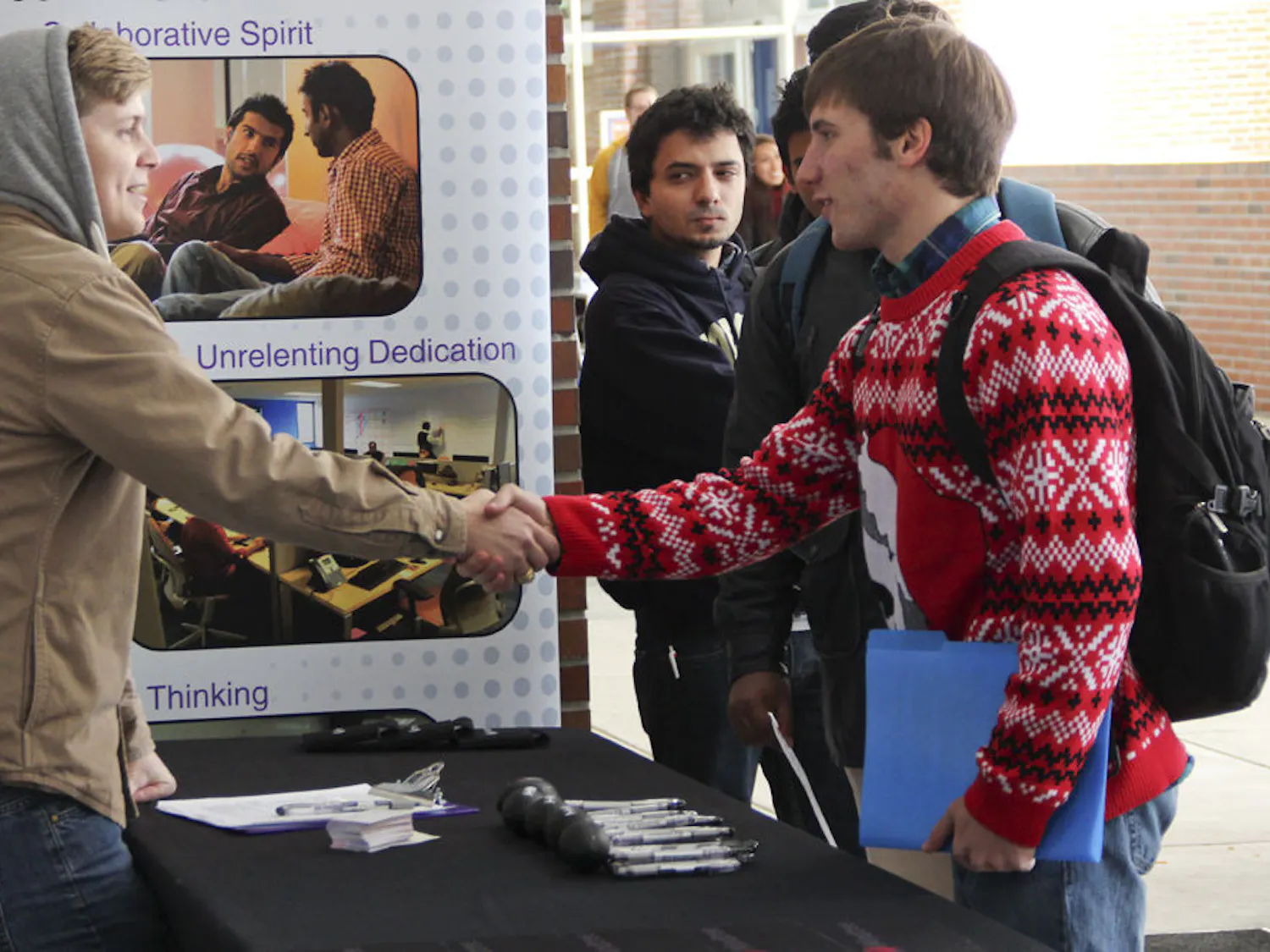 From right, Troy Halpin, a 20-year-old UF computer engineering sophomore meets Mindtree’s talent coordinator Rob Stolle, 28, at the Startup Job and Internship Fair on Tuesday afternoon. 