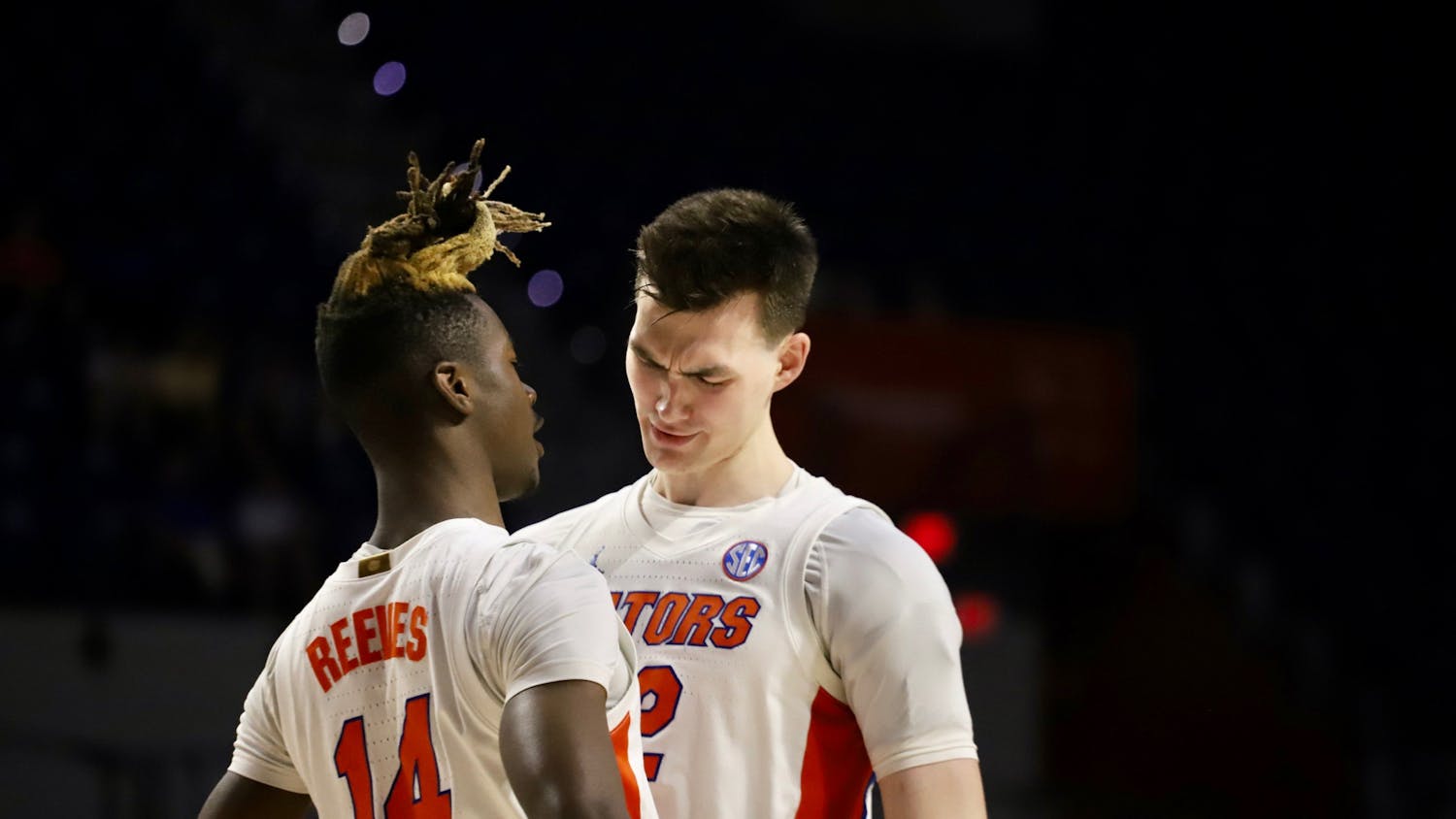 Guard Kowacie Reeves (left) and forward Colin Castleton (right) celebrate during Florida's win over Iona in the first round of the NIT Wednesday night. 