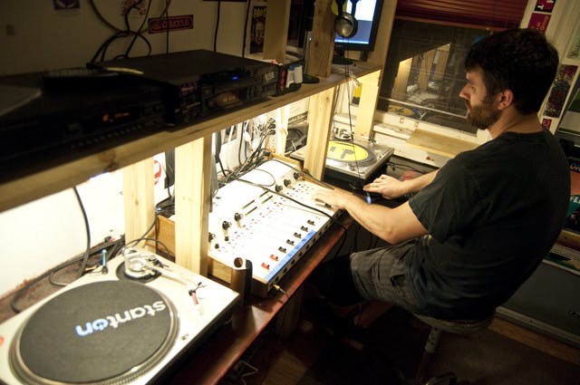 UF business graduate Dave Newell DJs his Thursday night hip-hop radio show, "Enjoy the Silence," in Grow Radio's studio, located downtown.