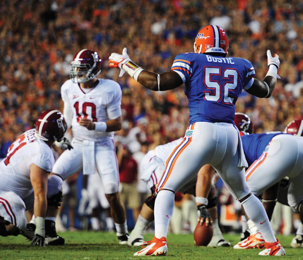 <p>Florida linebacker Jon Bostic (52) will not be suspended by coach Will Muschamp for throwing a punch at Alabama offensive lineman D.J. Fluker during the second quarter Saturday.</p>