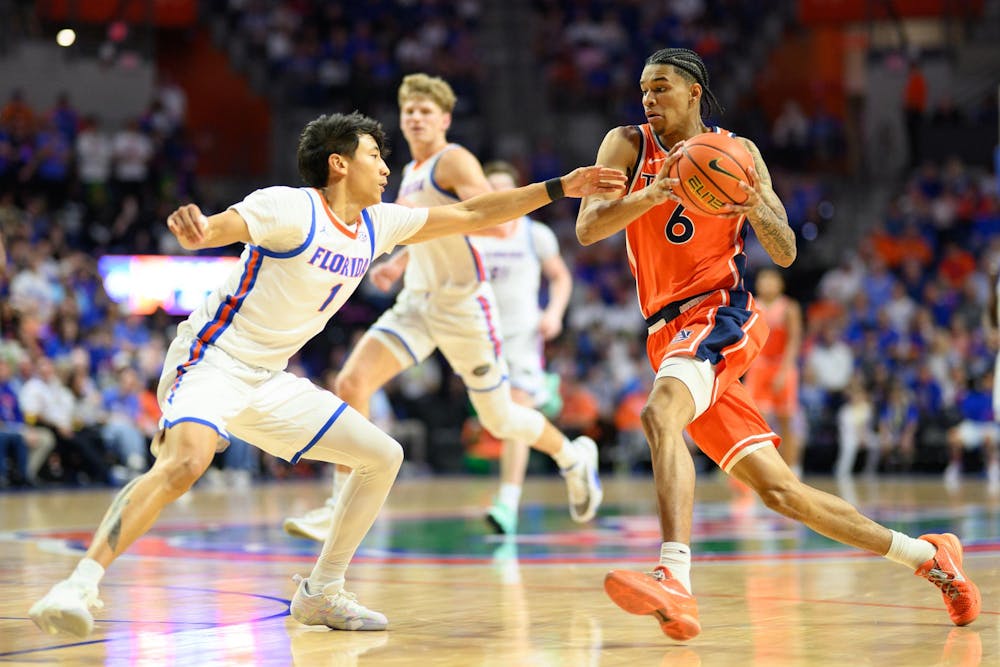 Auburn guard Elyjah Freeman (6) drives on Florida guard Xaivian Lee (1) during the second half of an NCAA college basketball game, Saturday, Jan. 24, 2026, in Gainesville, Fla.