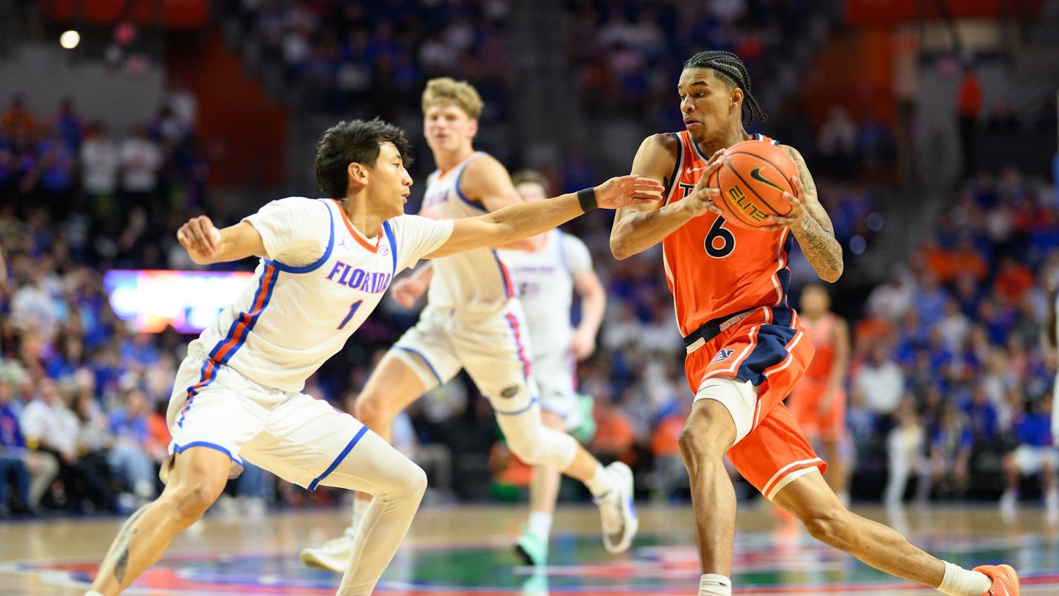 Auburn guard Elyjah Freeman (6) drives on Florida guard Xaivian Lee (1) during the second half of an NCAA college basketball game, Saturday, Jan. 24, 2026, in Gainesville, Fla.
