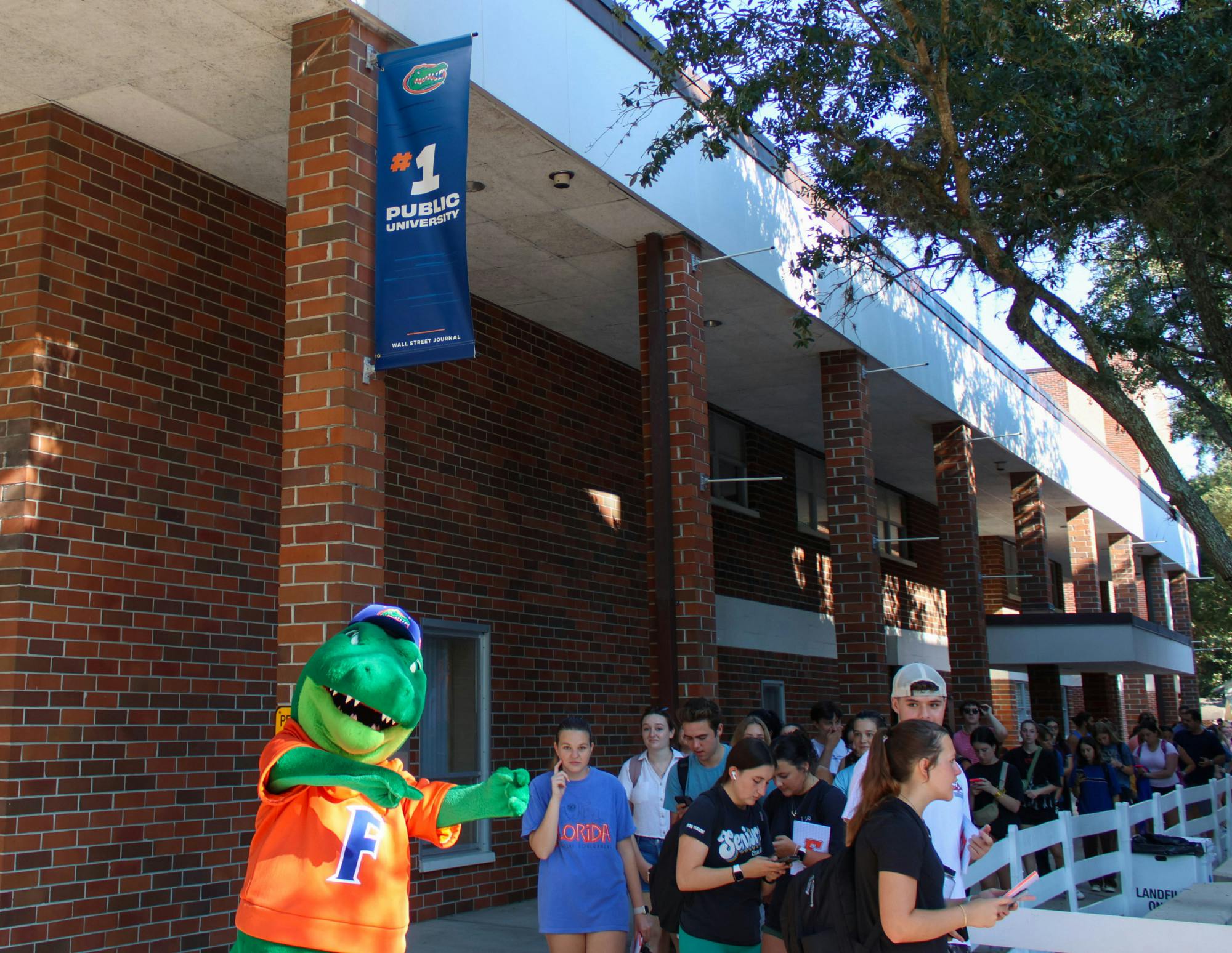 Students wait in line under the new #1 Public University banner outside of Emerson Alumni Hall on Friday, Sept. 15, 2023.