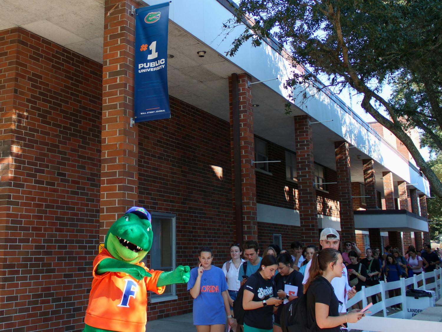 Students wait in line under the new #1 Public University banner outside of Emerson Alumni Hall on Friday, Sept. 15, 2023.