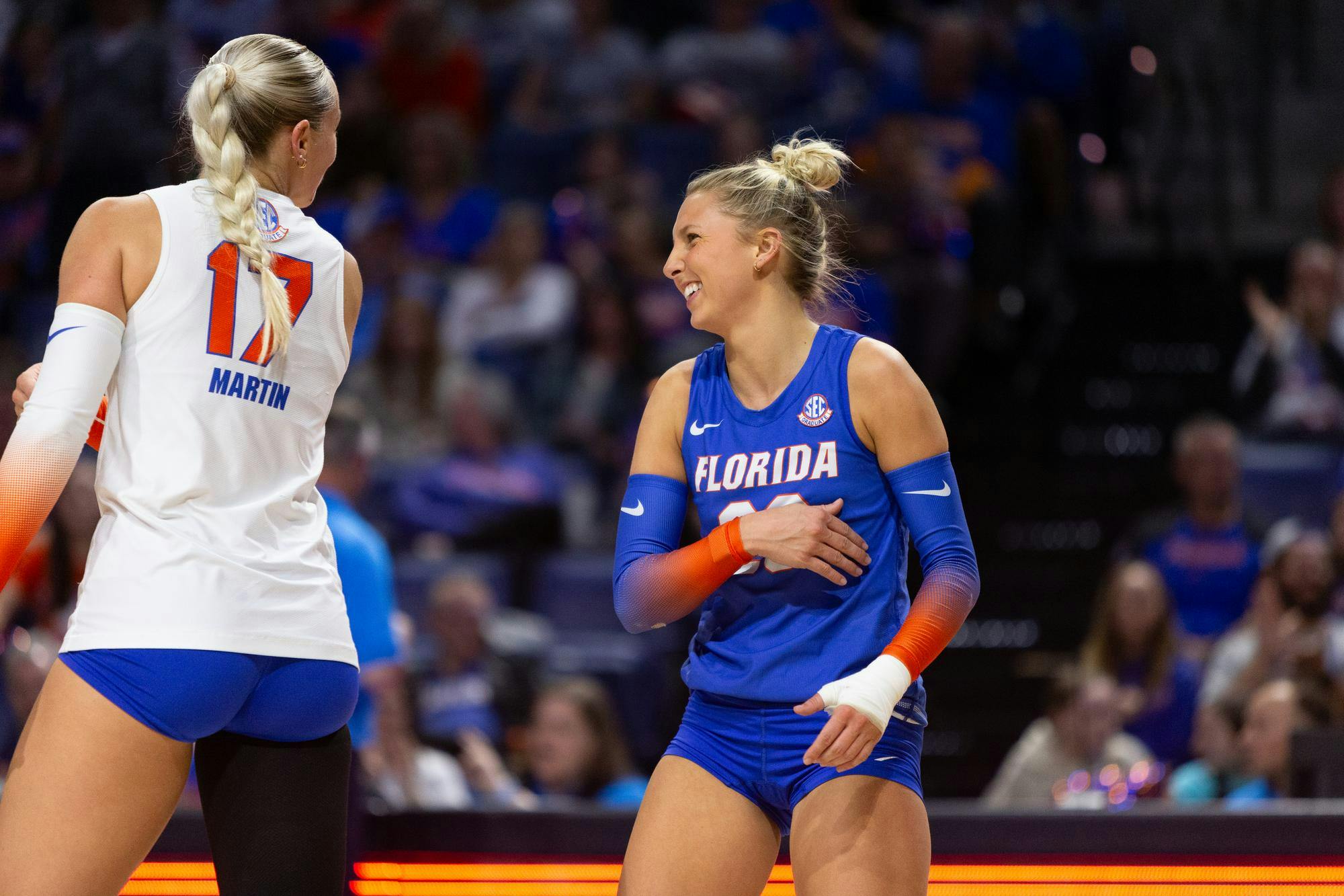 Florida Gators libero Elli McKissock (23) laughs with Florida Gators outside hitter Isabel Martin (17) after a timeout during the thrid set of the Gators’ match vs. the UCF Knights at Exactech Arena at the Stephen C. O'Connell Center on Saturday, Nov 23, 2024.