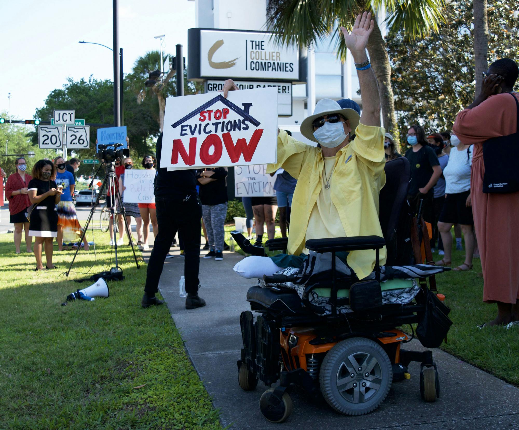 Hugh E. Suggs, 62, a Gainesville homeowner and author, protests outside of The Collier Company office in downtown Gainesville on Monday, May 3, 2021. Suggs was joined by about 25 other people protesting their landlords&#x27; tendency to prioritize higher paying tenants and ignore the needs of lower income families.
