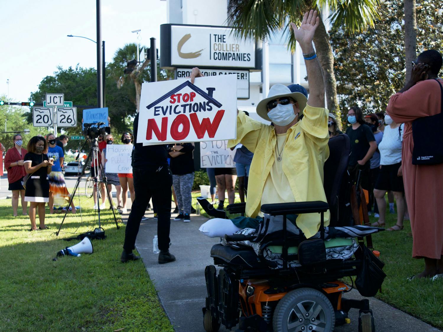 Hugh E. Suggs, 62, a Gainesville homeowner and author, protests outside of The Collier Company office in downtown Gainesville on Monday, May 3, 2021. Suggs was joined by about 25 other people protesting their landlords&#x27; tendency to prioritize higher paying tenants and ignore the needs of lower income families.