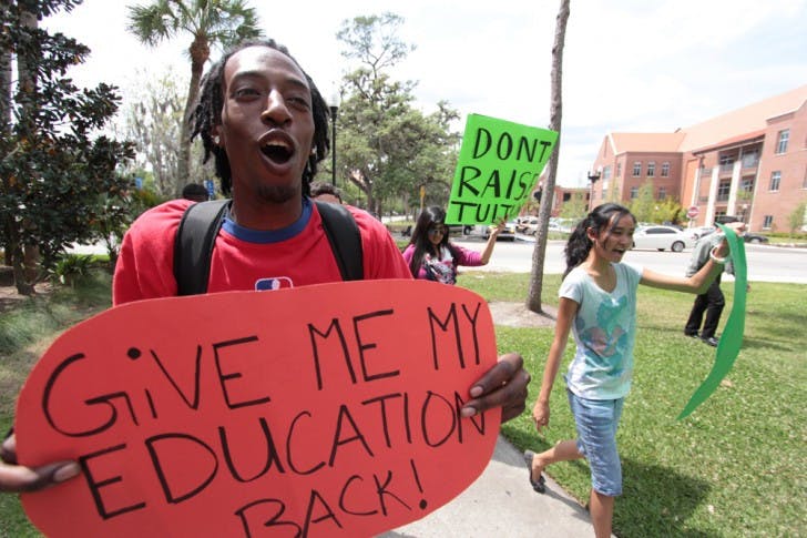 Students for a Democratic Society activist Jarrod Allen, 22, marches to Tigert Hall on Thursday afternoon to protest SB 1752, which would increase tuition.