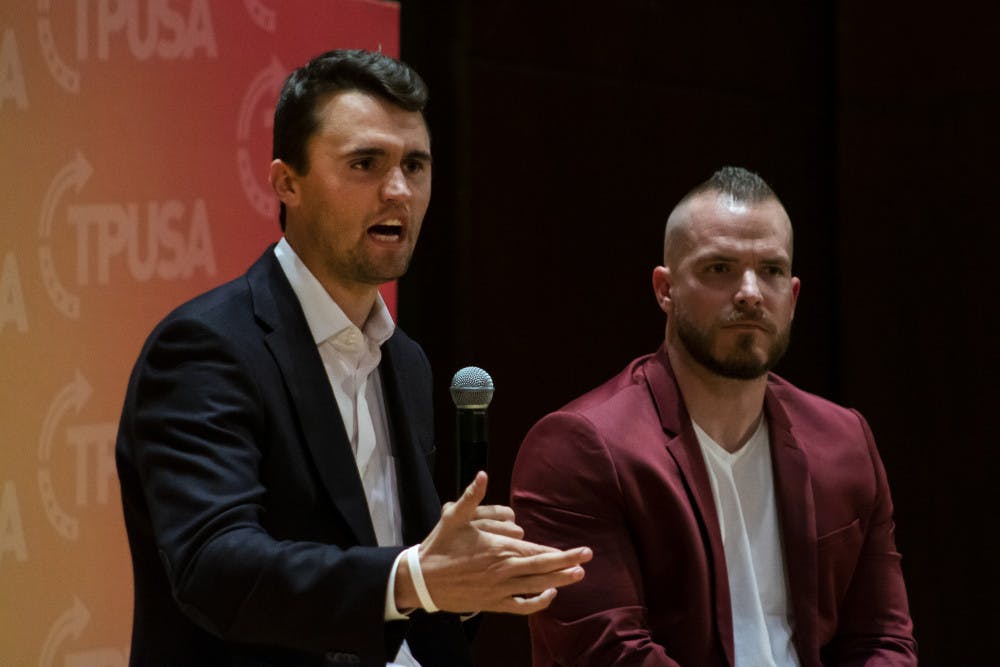Charlie Kirk, leader of Turning Point USA,  and Graham Allen, political speaker, answer questions from the audience Tuesday night in University Auditorium. Many of Kirk’s answers were met with a mixture of cheers and boos from the crowd.