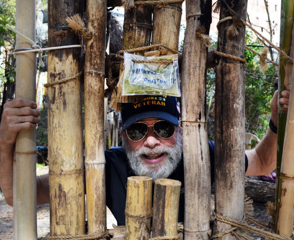 <p class="p1"><span class="s1">Jon Anderson, 67, poses in part of his interactive bamboo art exhibit, which is scheduled to be torn down in the next three days after UF ordered him to remove it.</span></p>