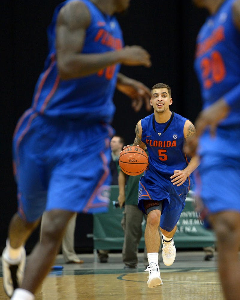 Scottie Wilbekin (5) brings the ball up the court for Florida against Jacksonville during the second half of the Gators’ 86-60 victory against the Dolphins on Monday in Jacksonville.