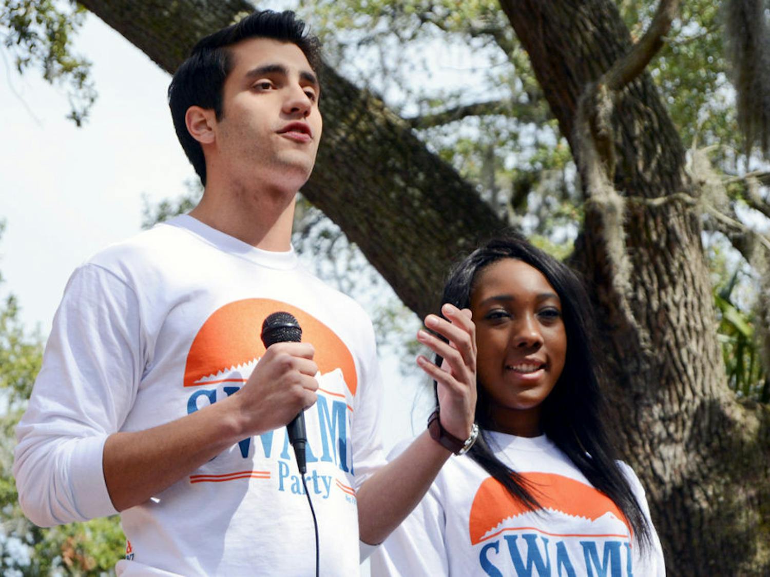 Joseph Michaels (left), Swamp Party’s candidate for student body president, and Tia Smart, Swamp Party’s candidate for student body vice president, release the party’s platform to a crowd of students on Turlington Plaza on Monday morning.