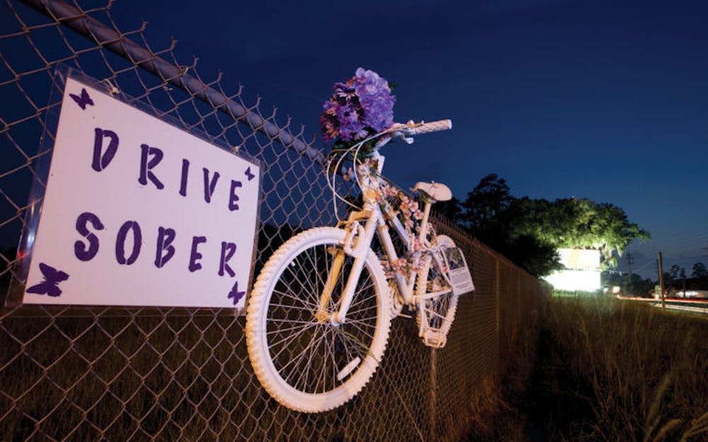 <p>A ghost bike hangs at the intersection of Southwest 16th Avenue and Archer Road on Monday night in memorial of Rebecca Harris, a UF student who was killed in a hit and run last year. &nbsp;</p>
<div>&nbsp;</div>