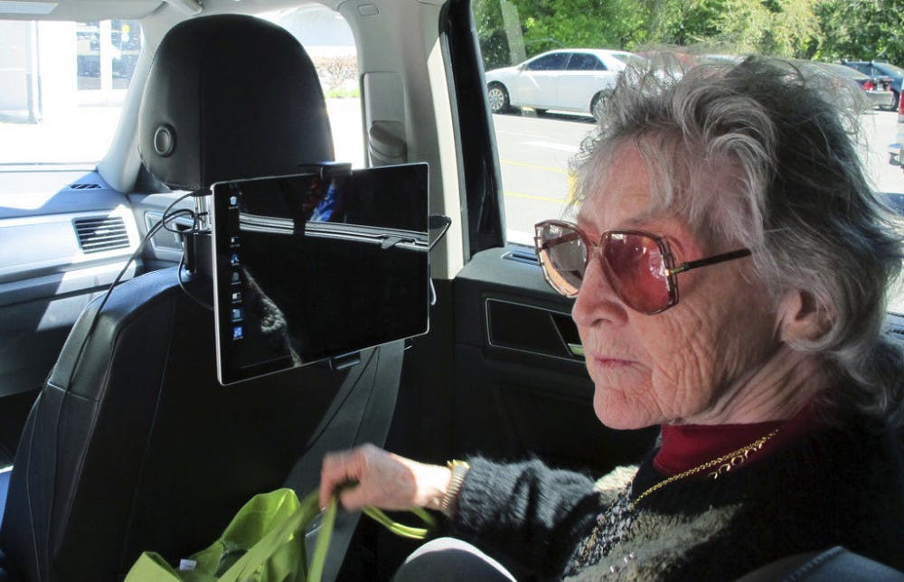 In this photo taken Wednesday, March 7, 2018, shows Sharon Van Etten, listening to a computerized voice in a vehicle equipped with software meant to help the visually impaired interact with self-driving cars in Ocala, Fla. Six years after a video went viral of a blind man going through a drive thru in a self-driving car, advocates for visually impaired people worry the industry is leaving them behind as they develop the cars of the future. So prominent groups are turning to university researchers like Brinkley to help build systems that will unlock the potential of autonomous cars' for the blind.&nbsp;