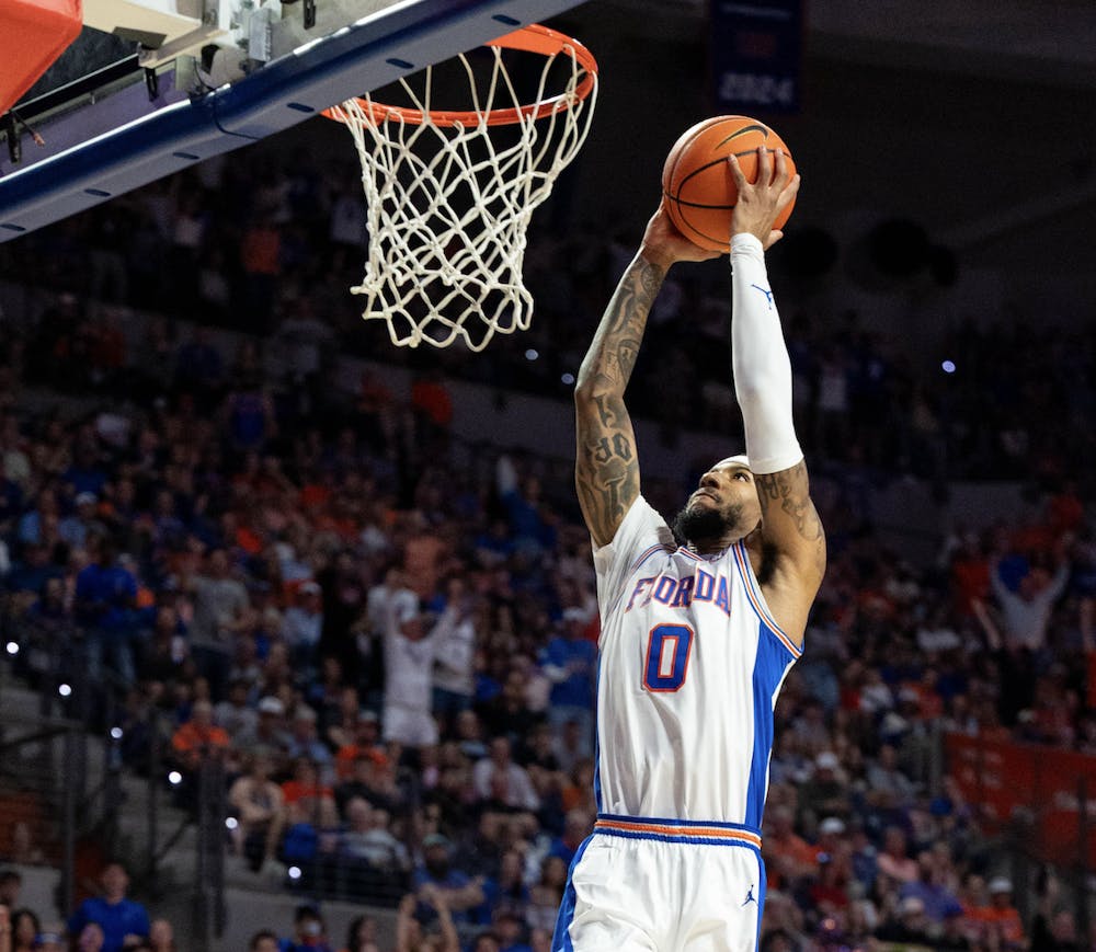Florida guard Boogie Fland (0) dunks during the first half of an NCAA college basketball game against Kentucky, Saturday, Feb. 14, 2026 at Exactech Arena in Gainesville, Fla.
