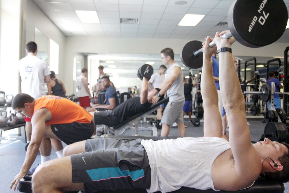 Daniel Taylor, a 22 year old International Business graduate student, lifts weights Wednesday at the Student Recreational Center.