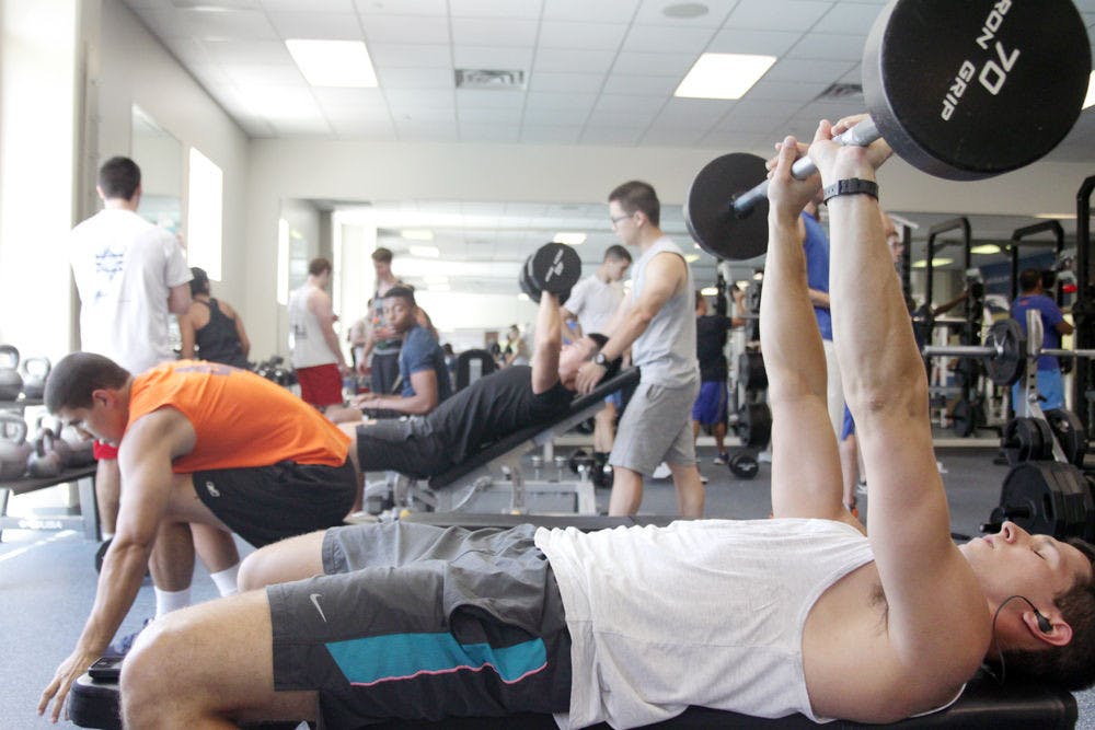 <p>Daniel Taylor, a 22 year old International Business graduate student, lifts weights Wednesday at the Student Recreational Center.</p>