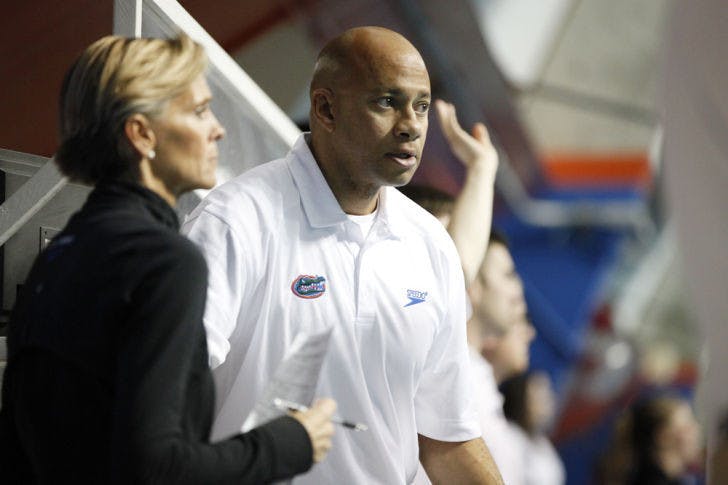 UF associate head coach Anthony Nesty (right) watches during Florida’s dual-meet sweep against Tennessee on Feb. 1 in the O’Connell Center. Nesty said the Gators need to excel in relays to win the SEC championship.
