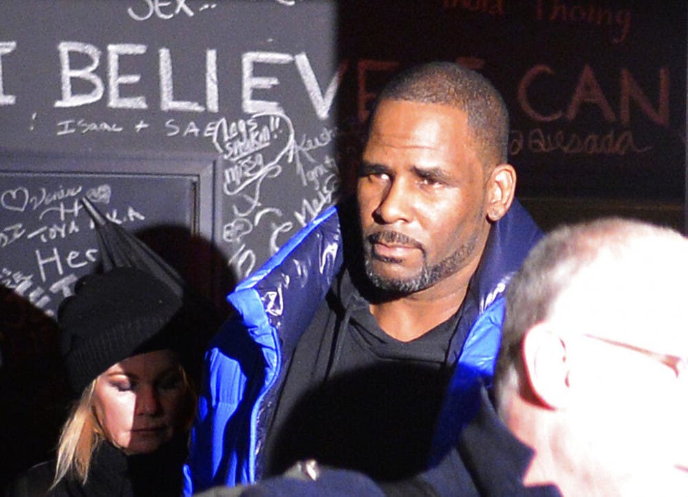 Musician R. Kelly leaves his Chicago studio Friday night, Feb. 22, 2019, on his way to surrender to police. R&amp;B star Kelly was taken into custody after arriving Friday night at a Chicago police precinct, hours after authorities announced multiple charges of aggravated sexual abuse involving four victims, including at least three between the ages of 13 and 17. (Victor Hilitski/Chicago Sun-Times via AP)