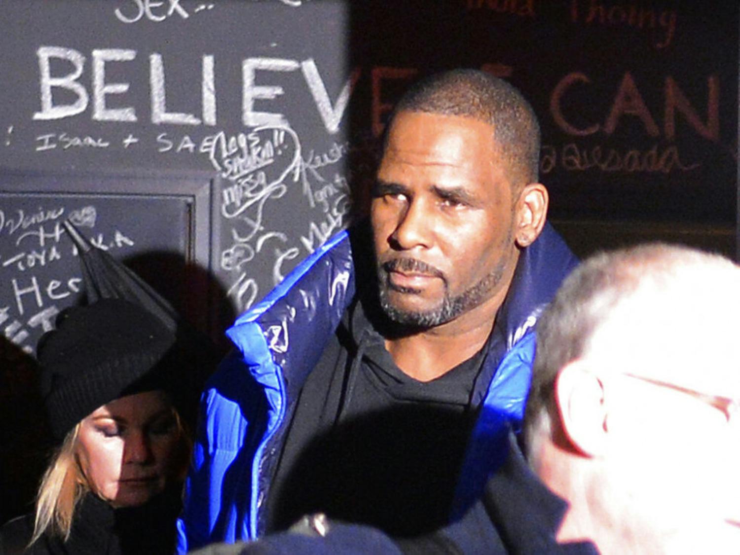 Musician R. Kelly leaves his Chicago studio Friday night, Feb. 22, 2019, on his way to surrender to police. R&amp;B star Kelly was taken into custody after arriving Friday night at a Chicago police precinct, hours after authorities announced multiple charges of aggravated sexual abuse involving four victims, including at least three between the ages of 13 and 17. (Victor Hilitski/Chicago Sun-Times via AP)